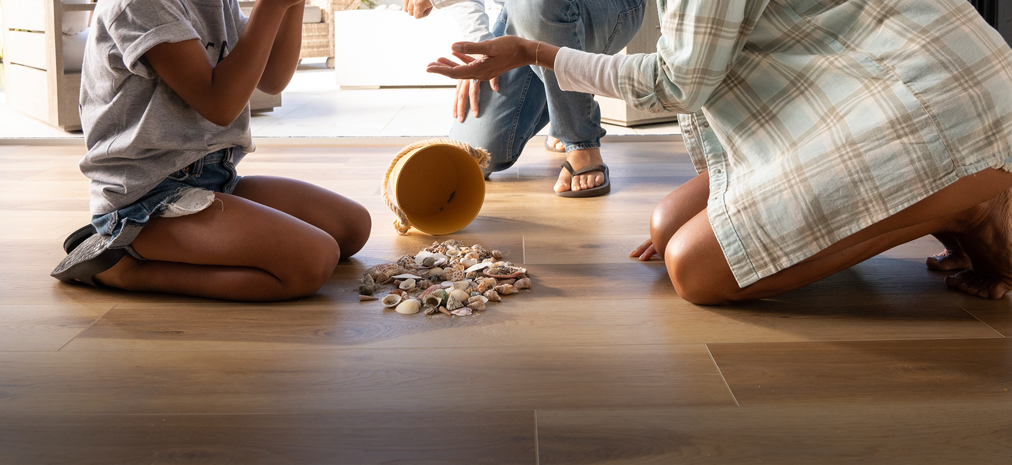 Family with seashells on Cantina Oak vinyl flooring