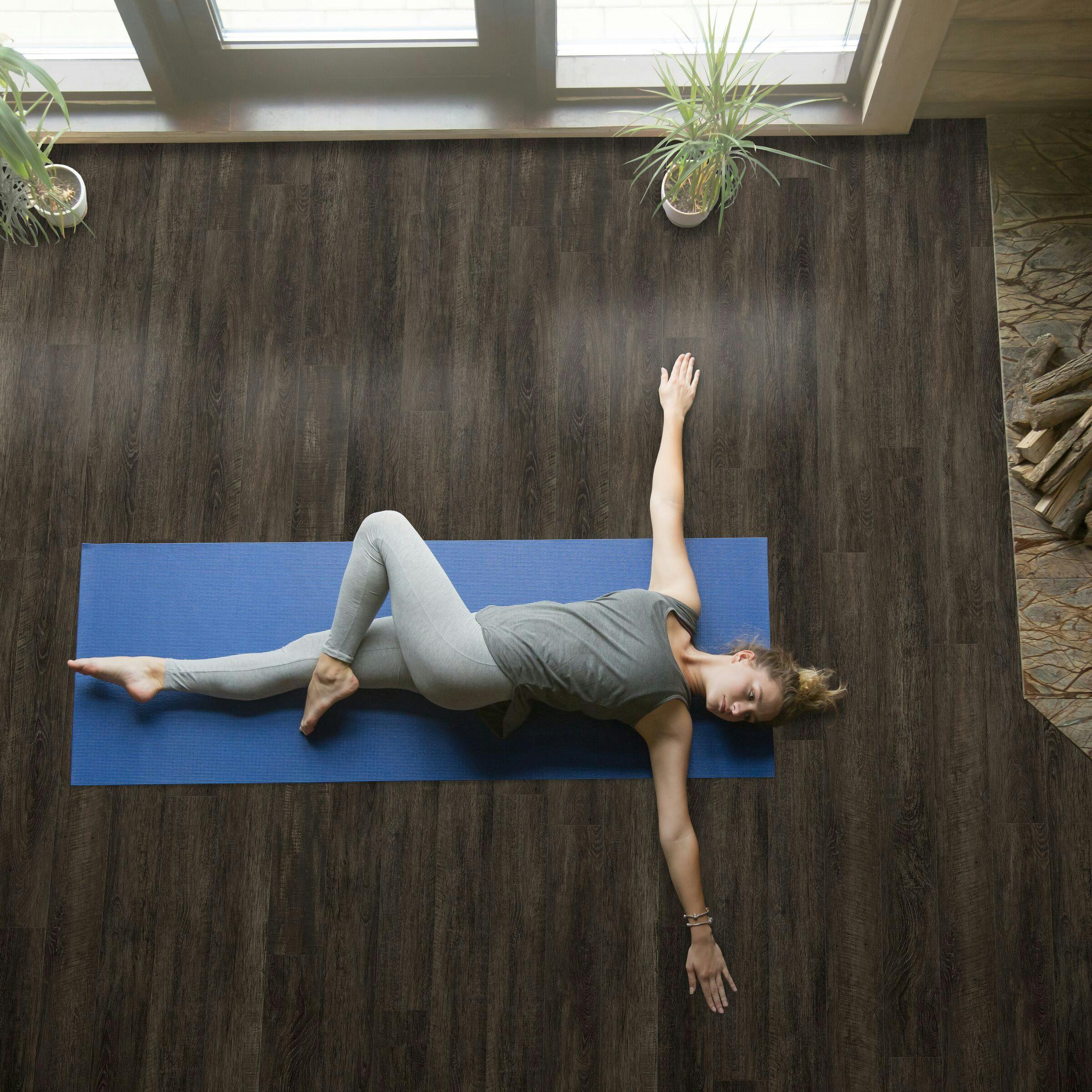 Woman performing yoga on CALI Floors.